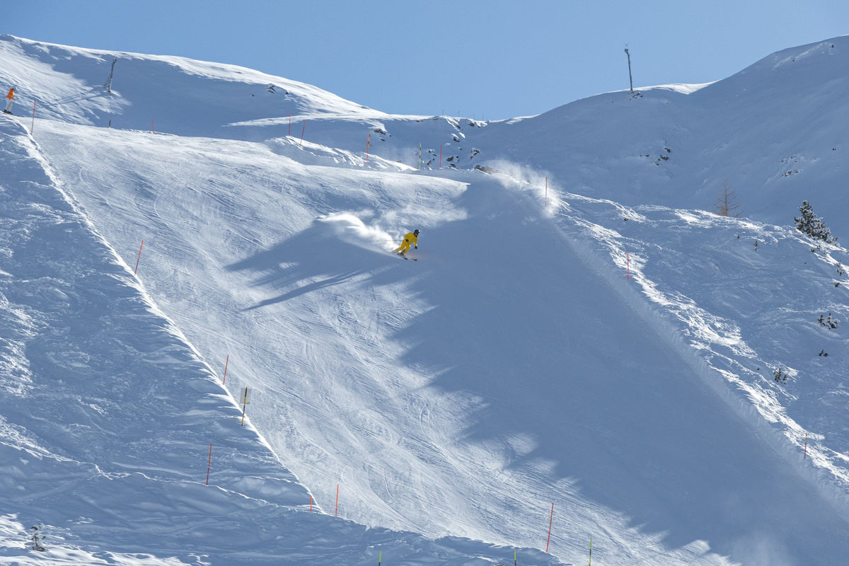 Lone skier in a wide snowy bowl