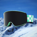 Alpine spherical anti-fog ski goggles, Green lens, on a snowy mountain backdrop