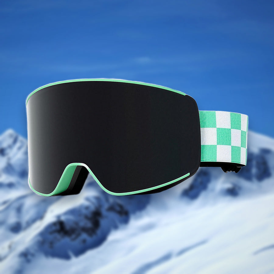 Alpine spherical anti-fog ski goggles, Green lens, on a snowy mountain backdrop