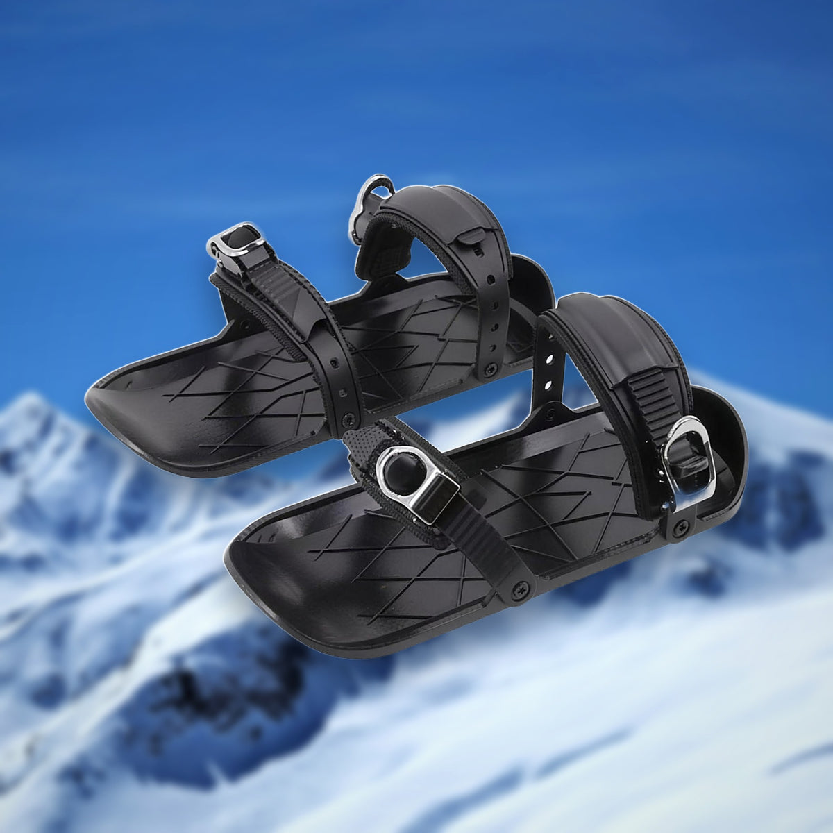 Pair of Alpine Snow Skates mini skis in black with adjustable bindings, on a snowy mountain backdrop