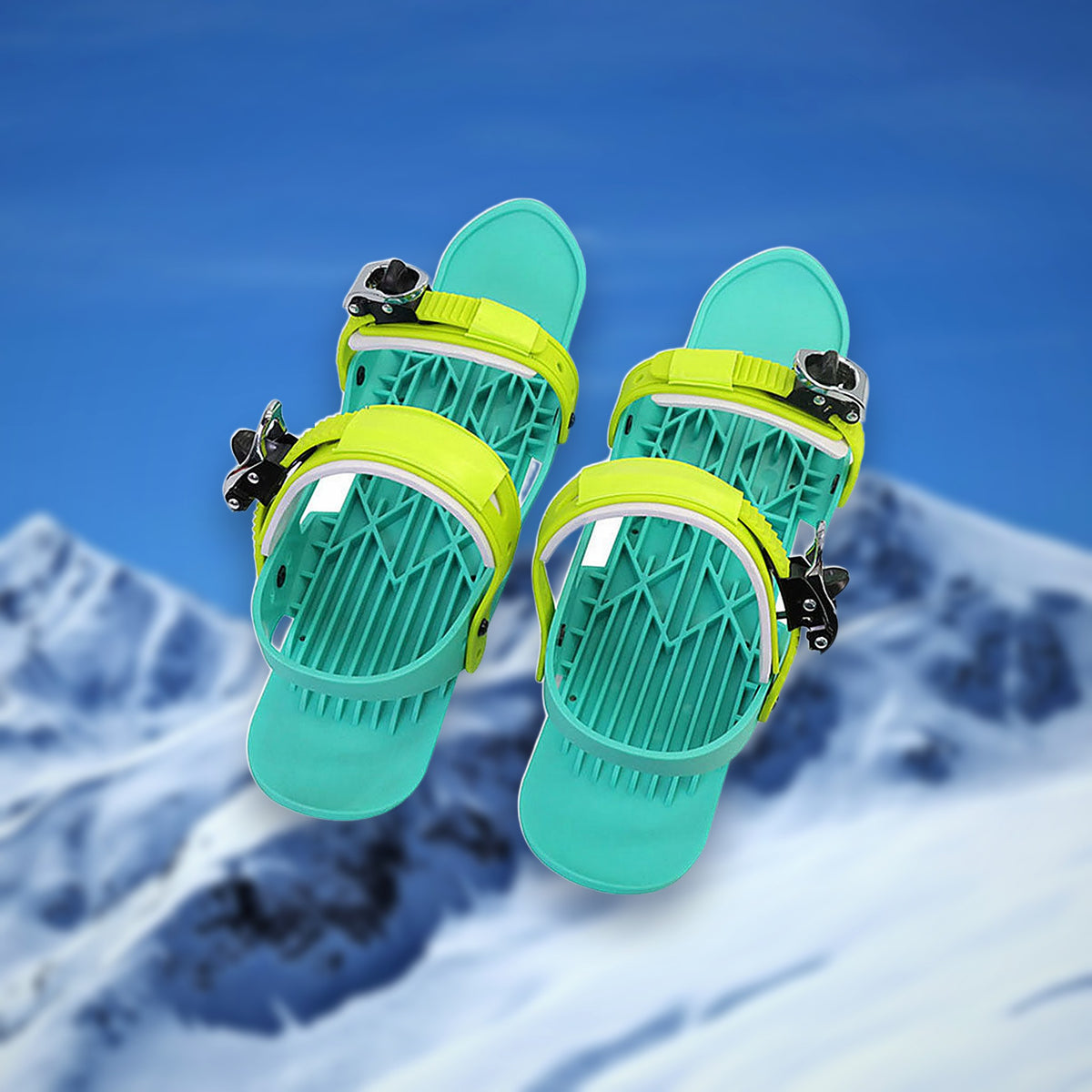 Pair of Alpine Snow Skates mini skis in green with adjustable bindings, on a snowy mountain backdrop