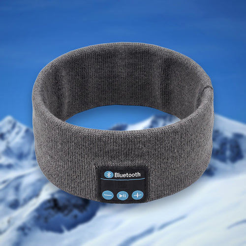 Tunes Band Bluetooth ski headband in dark grey, shown in the round on a snowy mountain backdrop