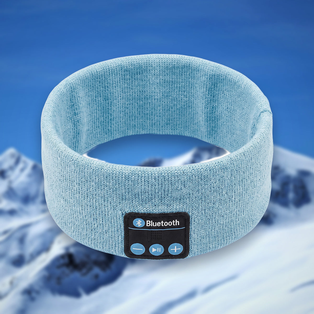 Tunes Band Bluetooth ski headband in light blue, shown in the round on a snowy mountain backdrop