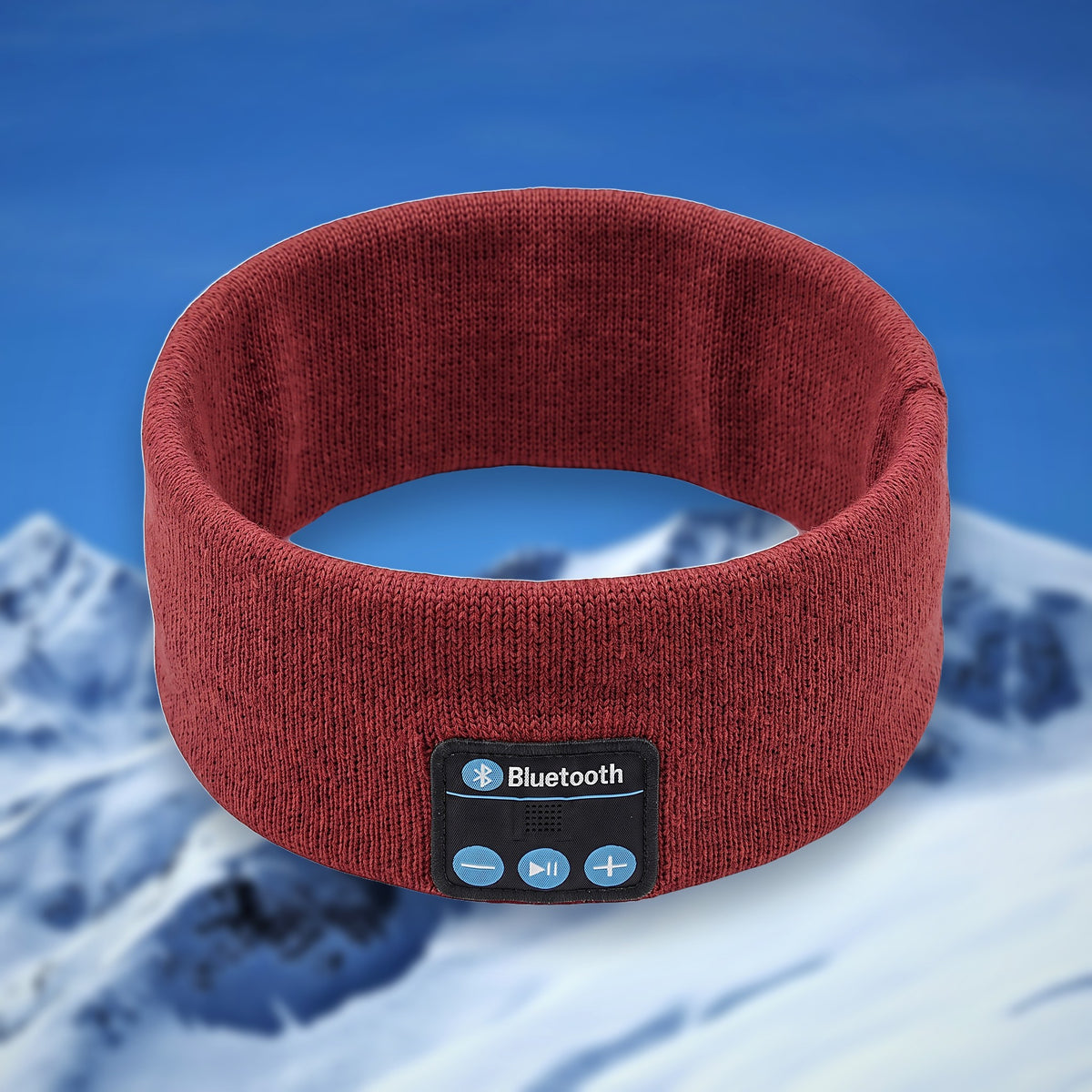 Tunes Band Bluetooth ski headband in red, shown in the round on a snowy mountain backdrop